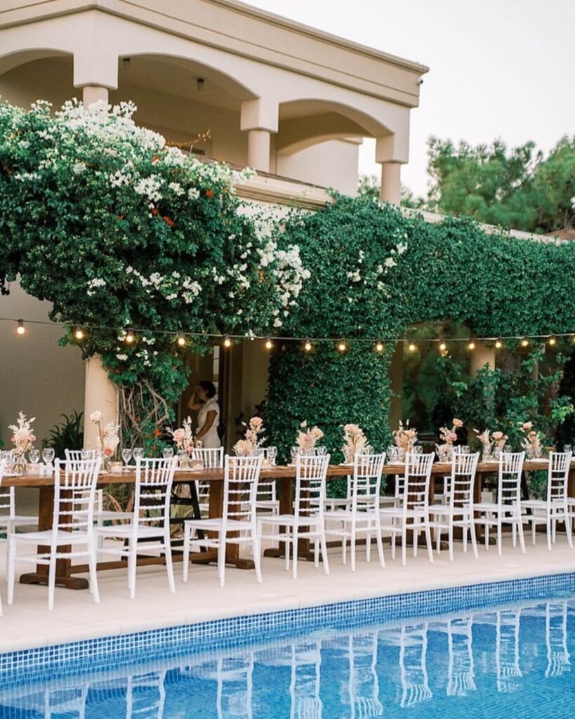 Wedding dining area at Bello Blu in Greece, with elegant table arrangements and fairy lights under the night sky.