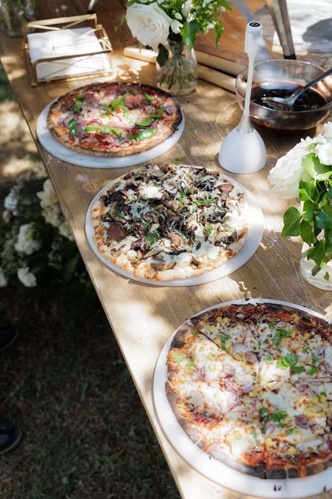 Selection of gourmet pizzas on rustic wooden table at Chateau de la Couronne.
