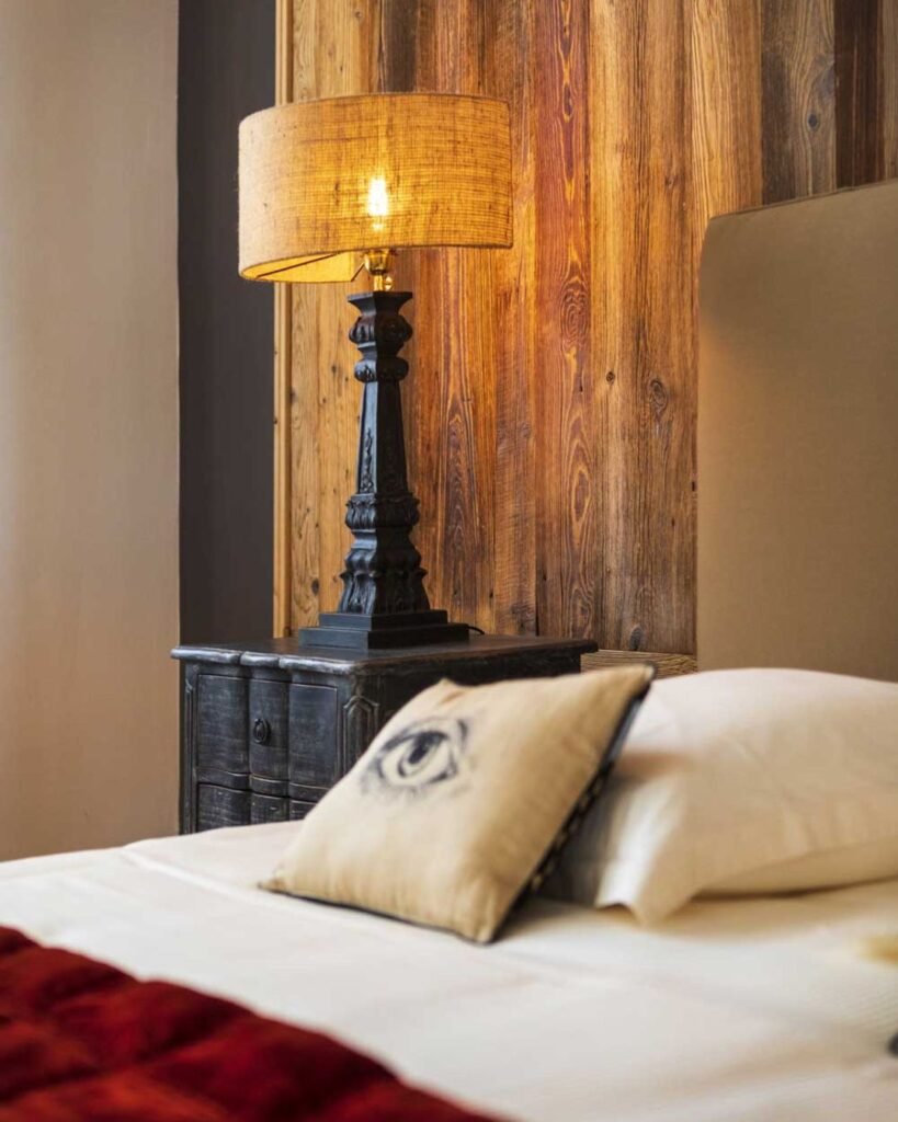 Luxurious bedroom suite at Chateau de Garde in France with vintage furnishings and natural light.