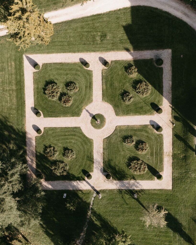The lush and meticulously maintained gardens surrounding Chateau de Garde, perfect for wedding celebrations and outdoor photography.