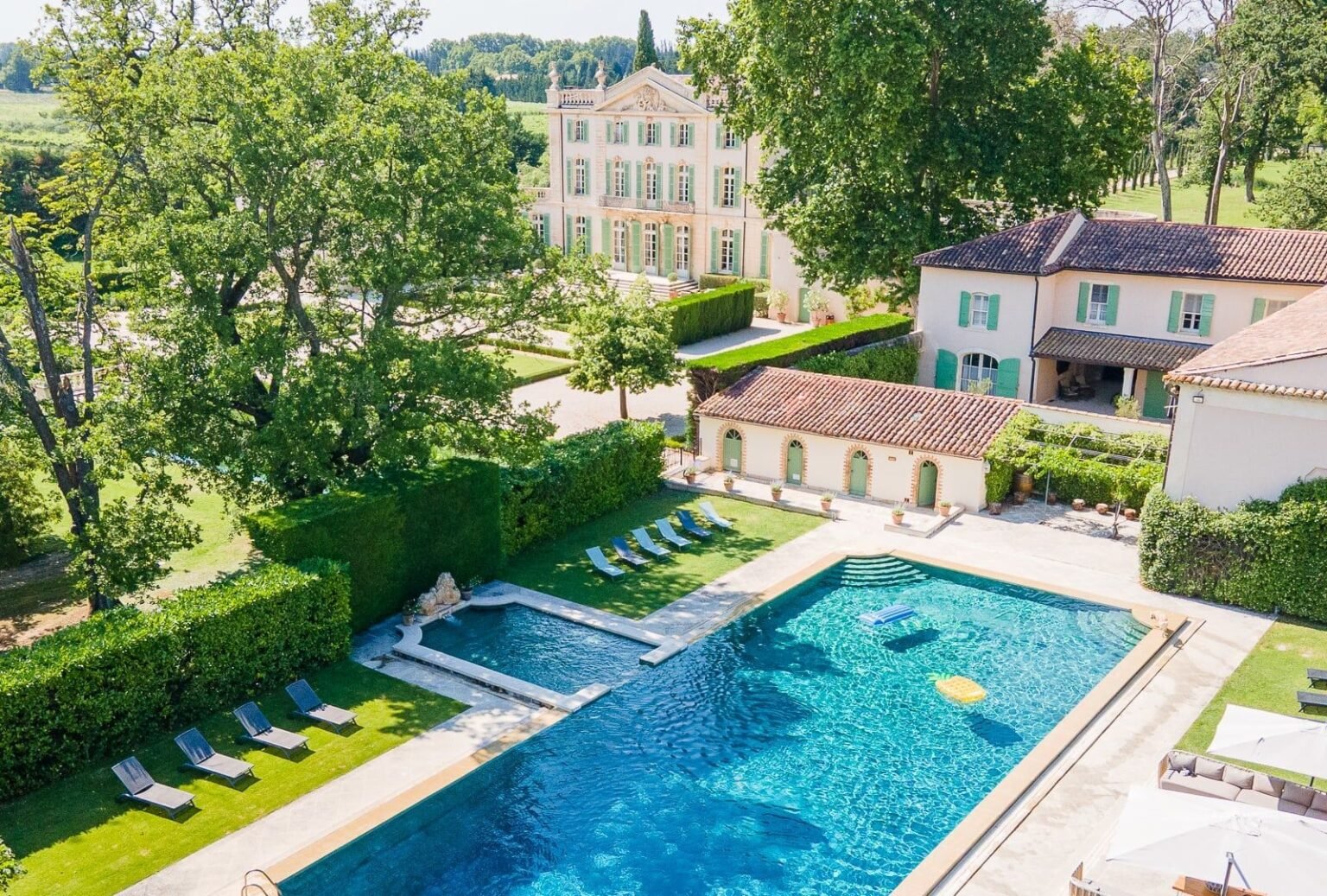 Aerial view of Chateau de Tourreau's pool and surrounding landscape.