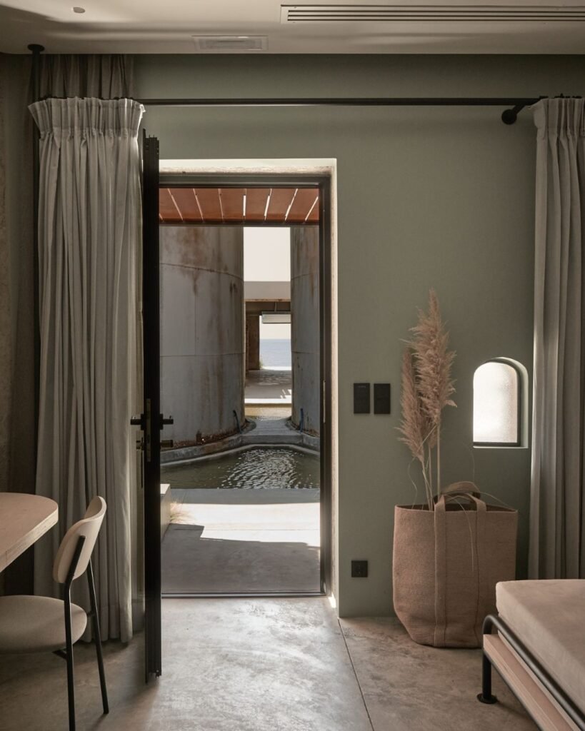 Spacious luxury suite at Dexamenes Seaside Hotel in Greece, featuring a comfortable seating area and contemporary decor.