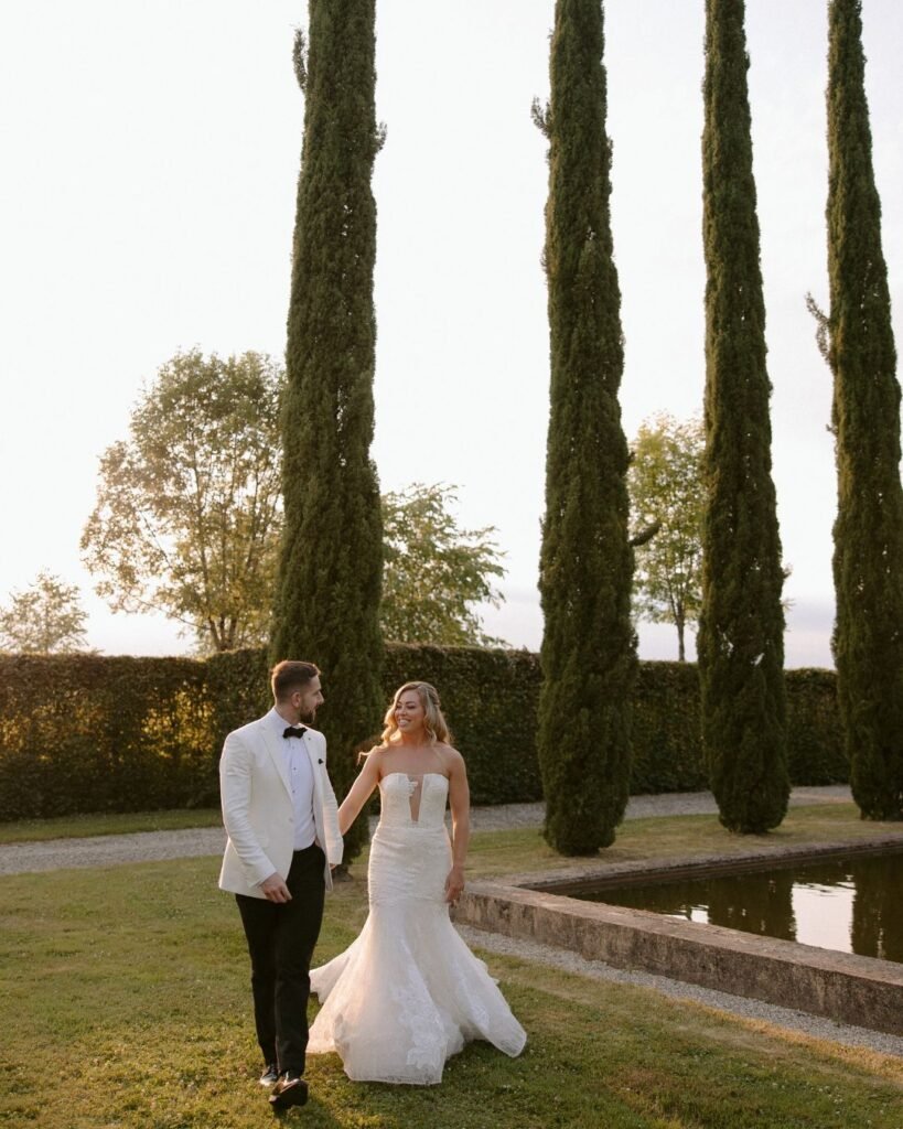 A timeless couple's portrait among the towering cypress trees, the elegant scenery adding to the charm of Domaine d'Essendieras.