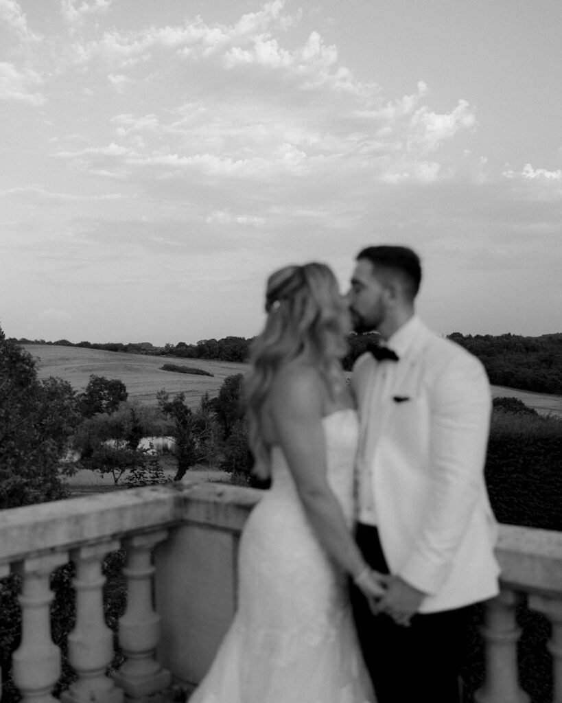 A romantic couple's portrait on the château terrace, framed by elegant stonework and sweeping views.