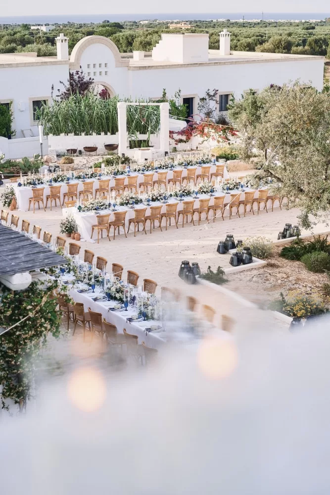 Long banquet tables set for an al fresco celebration at Masseria Calderisi