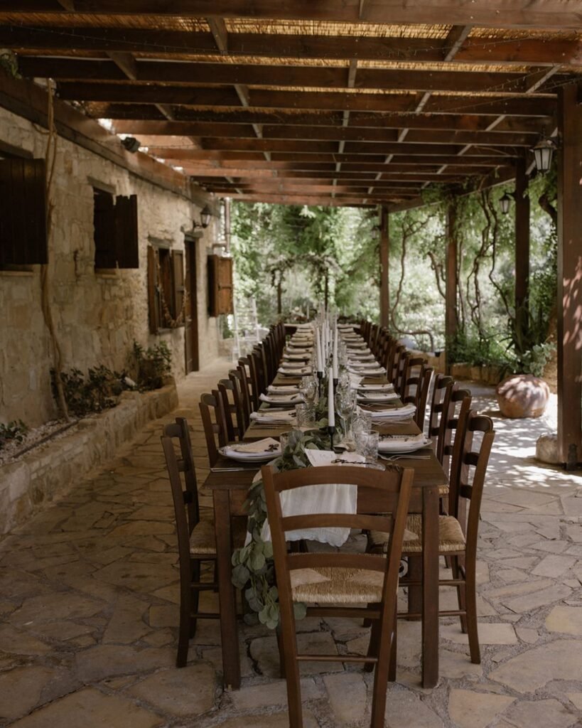 Charming wedding guest table setup at Vasilias Nikoklis Inn, with personalized name cards and floral centerpieces.