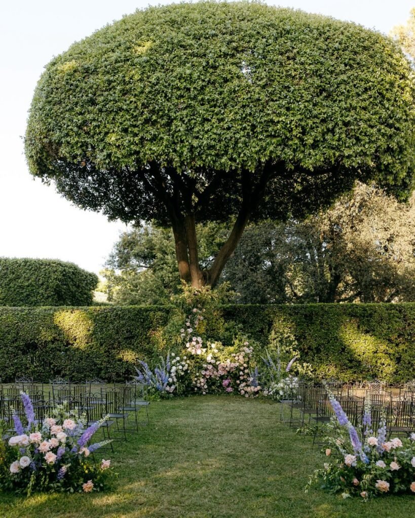 Elegant outdoor wedding ceremony setup at Villa Aurelia, with floral arrangements and stunning views, photographed by Paola Colleoni.