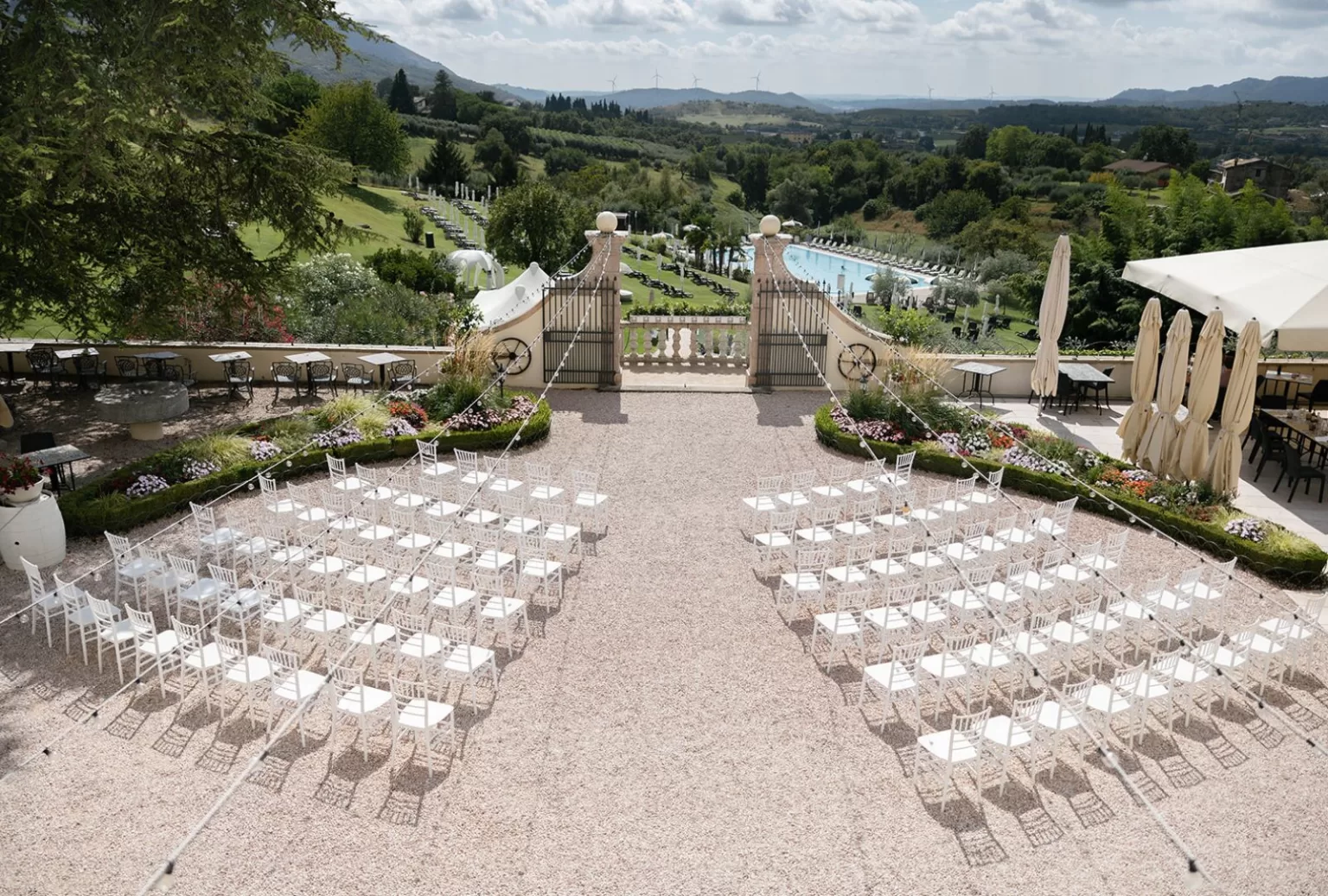 Elevated ceremony view showing symmetrical seating and lush countryside at Villa Cariola.
