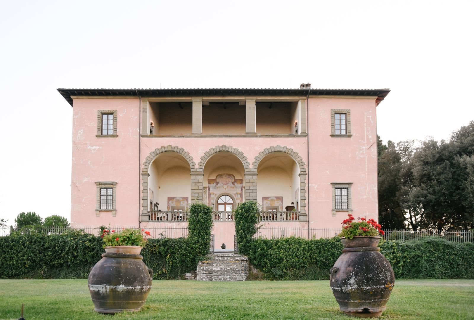 The majestic facade of Villa Mangiacane showcasing its Italian architecture and historic charm, surrounded by lush gardens