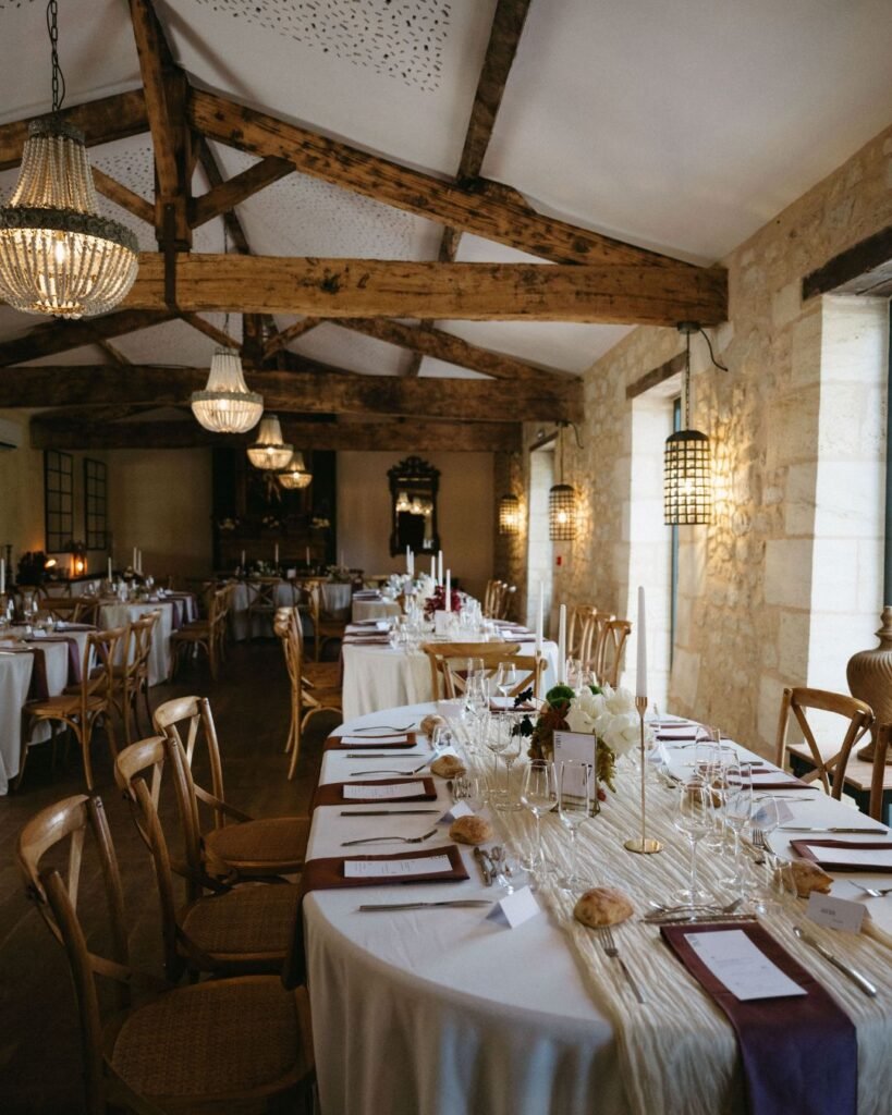Close-up of elegant table settings with candles, greenery, and floral arrangements at Chateau de Garde, photographed by Sam & Larissa.