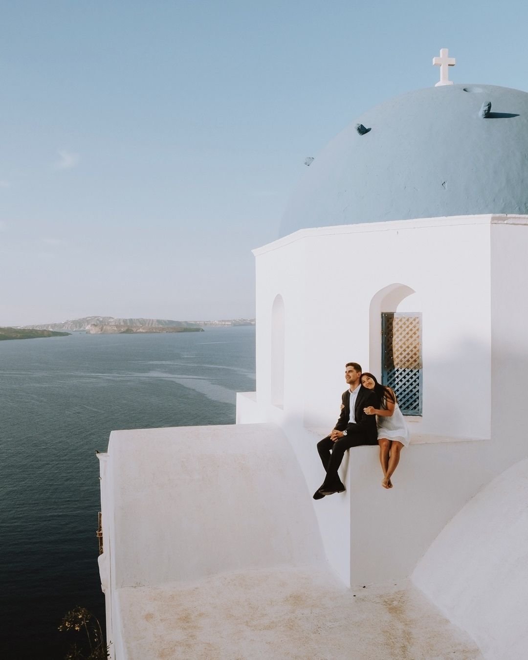 Bride and groom strolling through charming historic streets in Greece.