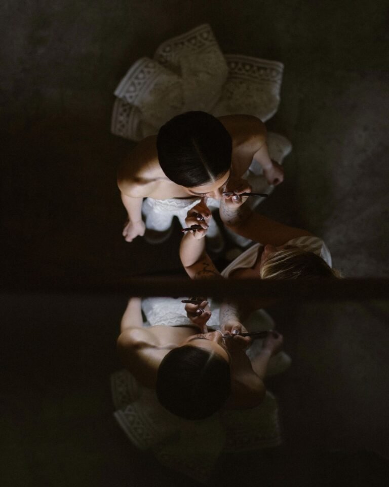 An artistic overhead portrait of the bride at Areias do Seixo, capturing the soft elegance of her gown and delicate details.