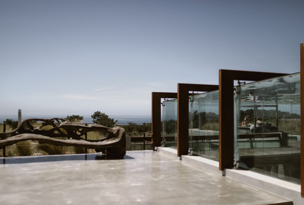 Areias do Seixo at dusk, its modern architecture blending seamlessly with the surrounding coastal landscape.