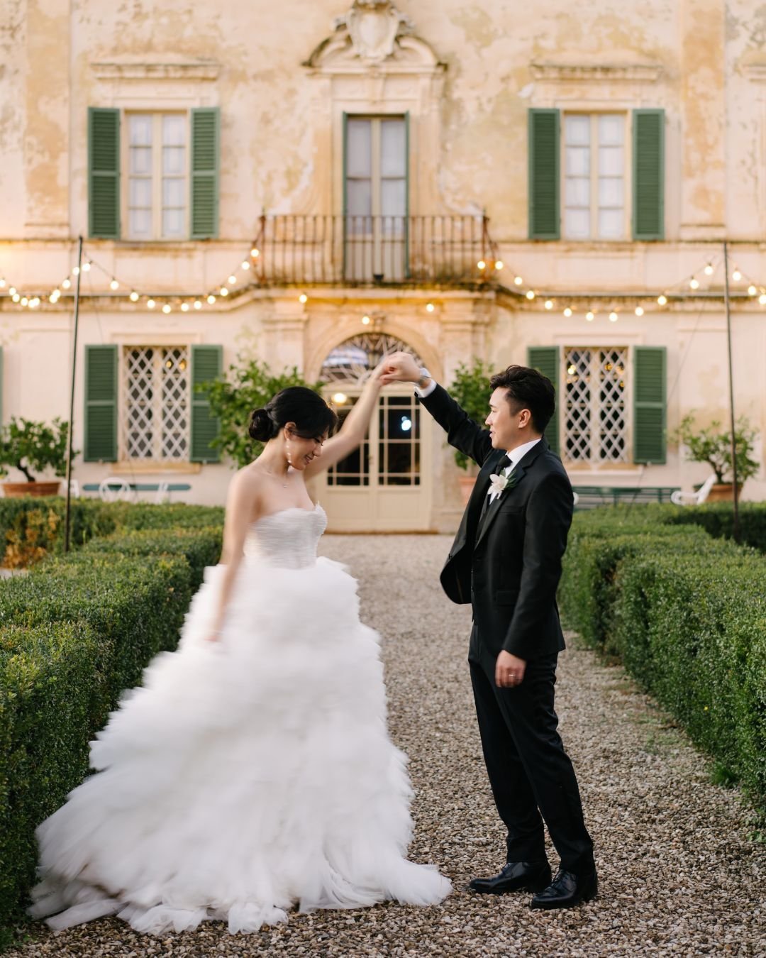 A candid moment of laughter between the bride and groom during their wedding day in Tuscany.