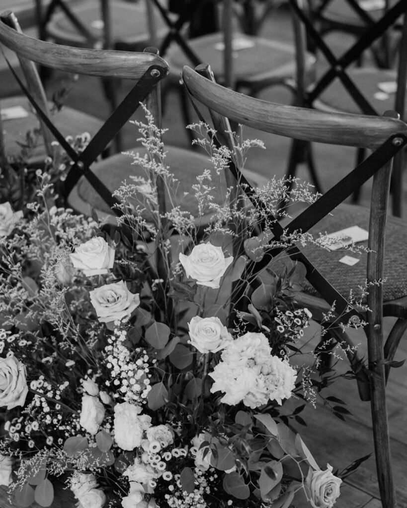 A close-up of a ceremony chair with delicate floral accents at Quercia al Poggio.