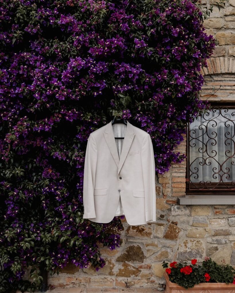 Trailing purple wisteria adorning the stone walls of Quercia al Poggio’s historic villa.