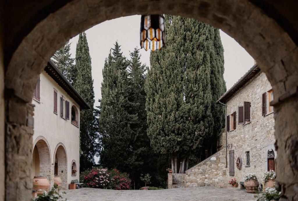 A charming stone courtyard with historic arches at Quercia al Poggio.