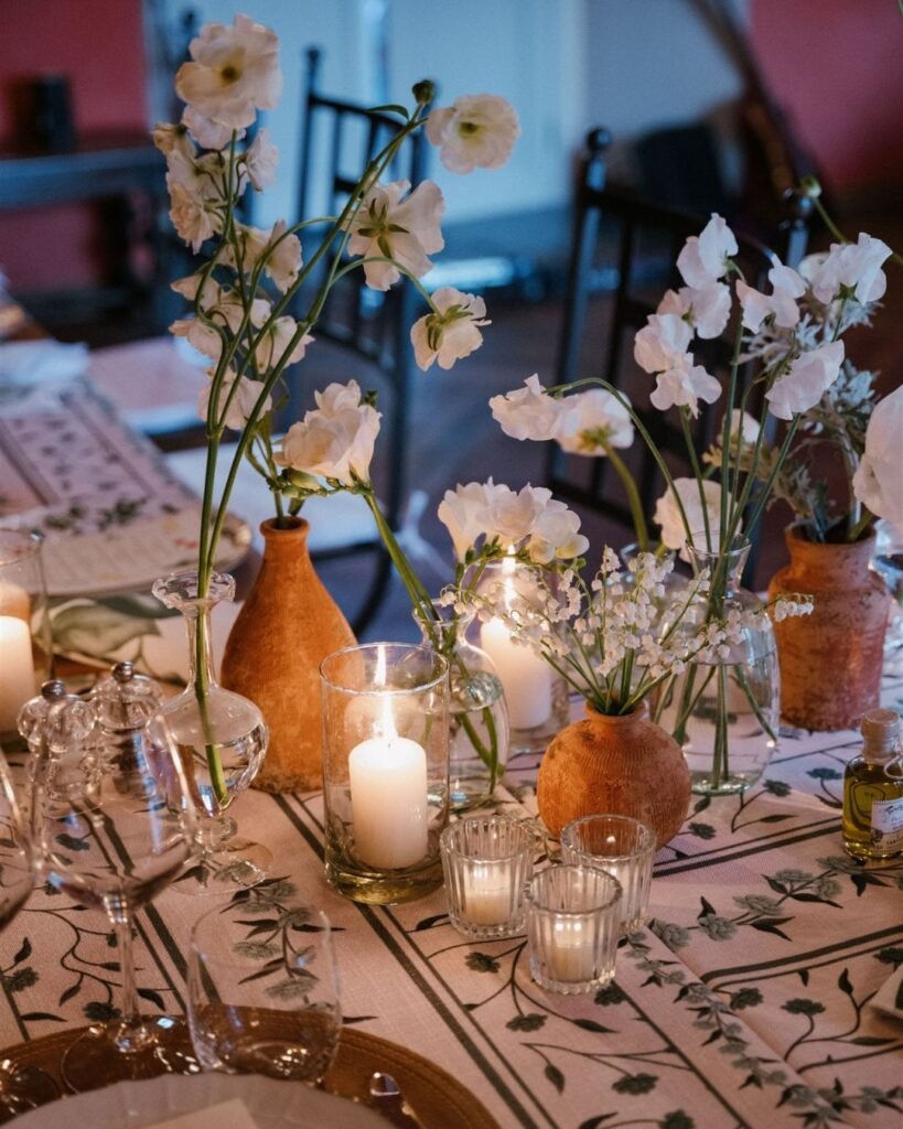 Soft candlelight enhances the romantic atmosphere of an indoor wedding reception at Rosewood Castiglion del Bosco.