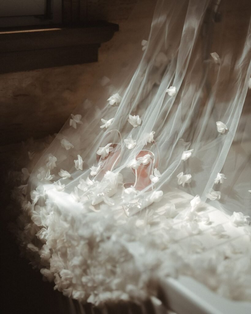The bride’s veil cascades beautifully as she stands in Villa Donna Camilla’s elegant hallway.