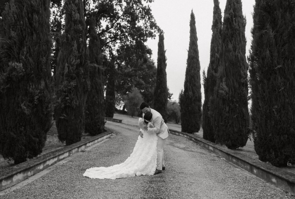A romantic moment as the couple shares a kiss at Villa Donna Camilla, surrounded by golden light.
