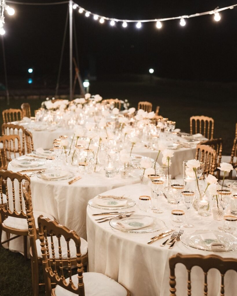 Elegant floral centerpieces adorn the candlelit reception tables at Villa Donna Camilla.