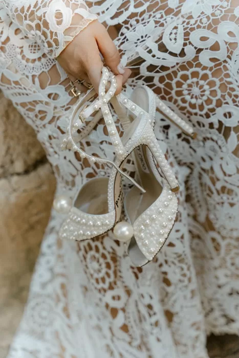 Elegant pearl-studded Jimmy Choo heels on a box in a vintage room at Borgo Stomennano