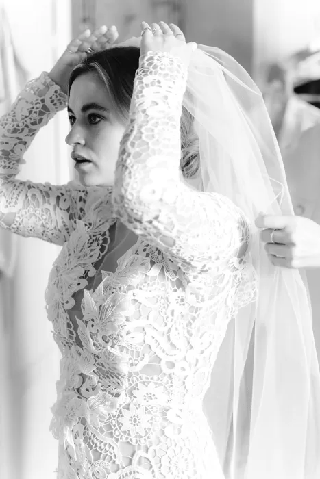 Bride adjusting her veil in a quiet, emotional moment at Borgo Stomennano