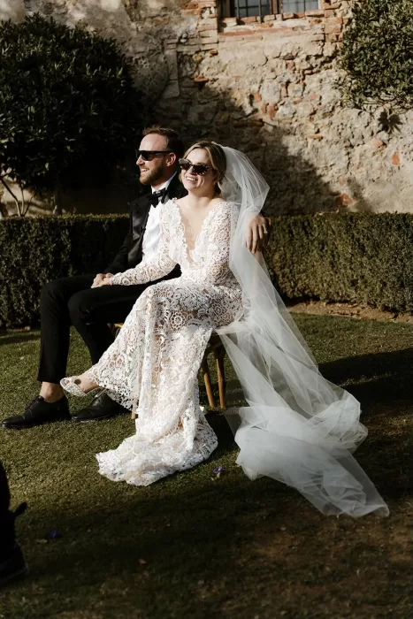 Couple smiling in the sunlight during their outdoor wedding ceremony at Borgo Stomennano