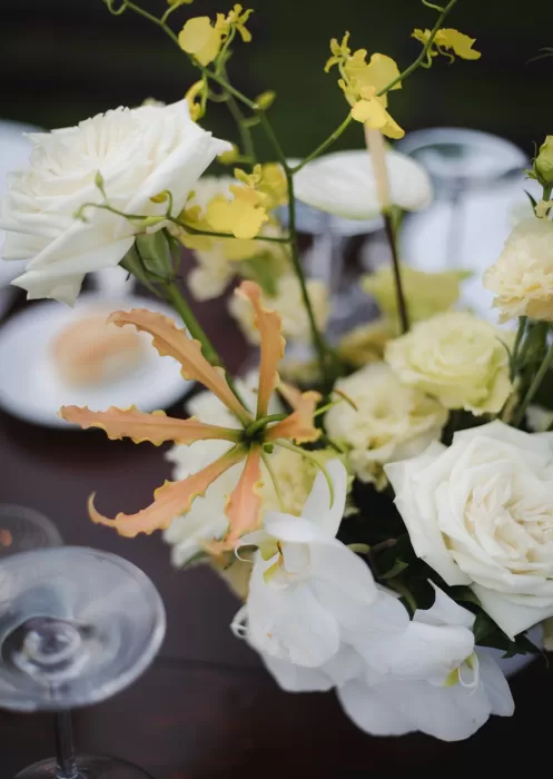 Close-up of soft yellow and cream flowers on a wedding table at Borgo Tre Rose.