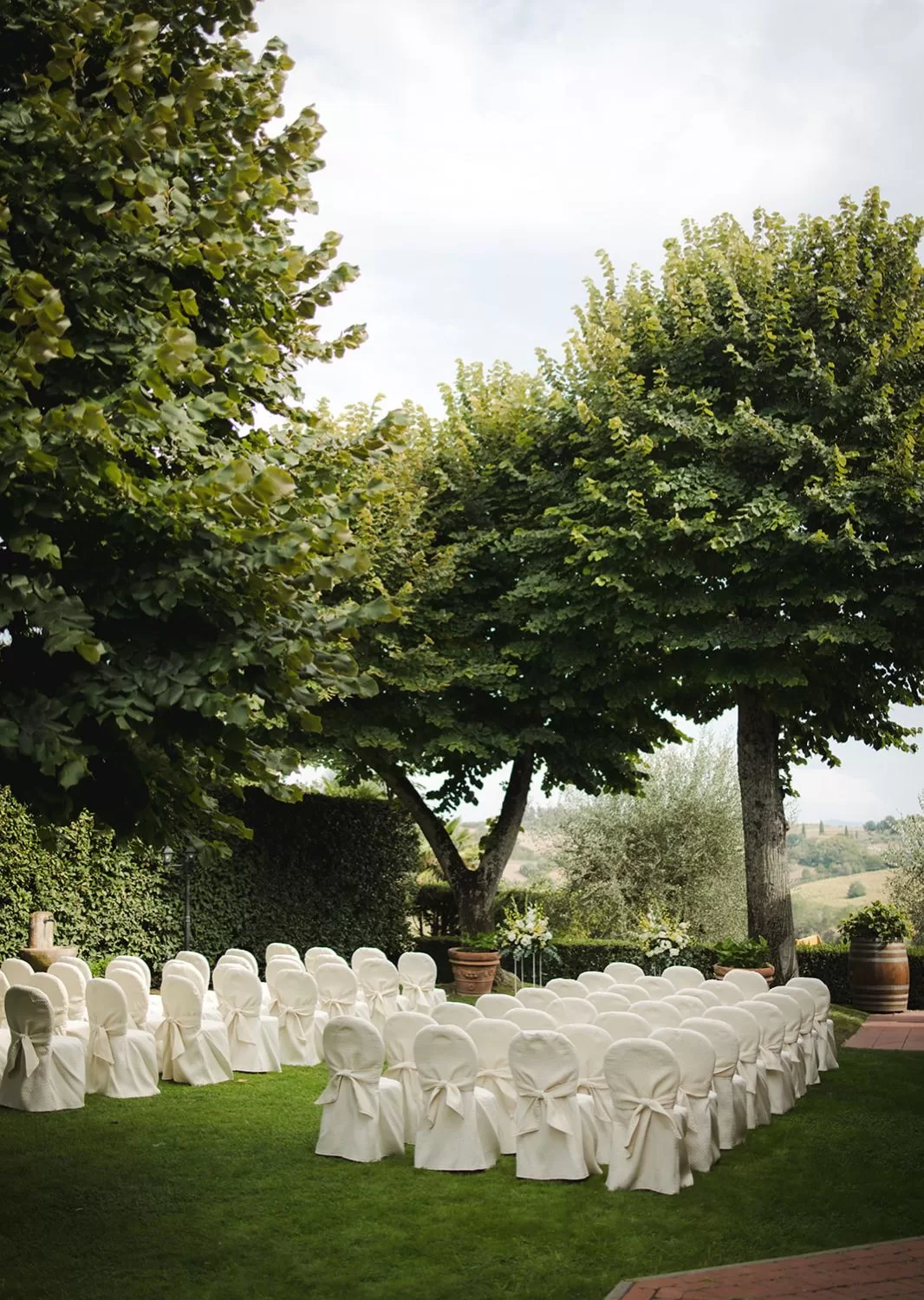 Peaceful ceremony garden with views of the Tuscan hills at Borgo Tre Rose.