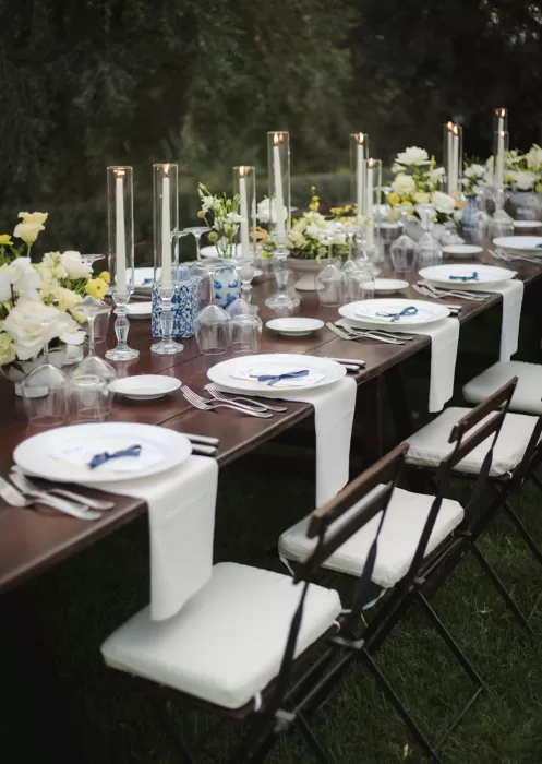 Elegant outdoor wedding table at Borgo Tre Rose with tapered candles and white floral arrangements.