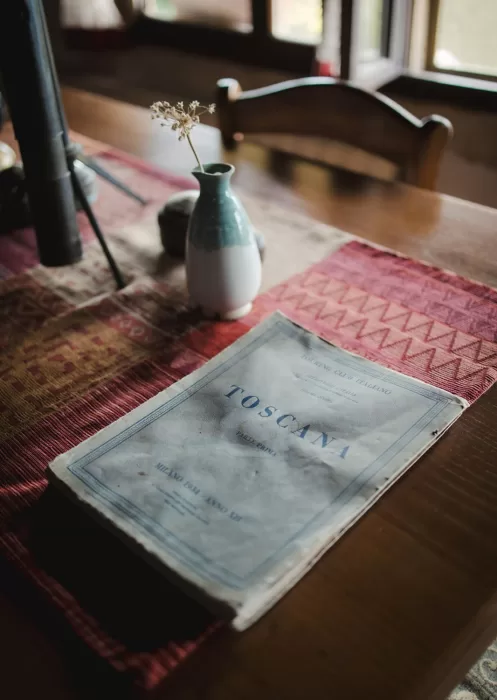 Vintage Toscana guidebook on a rustic table at Borgo Tre Rose.