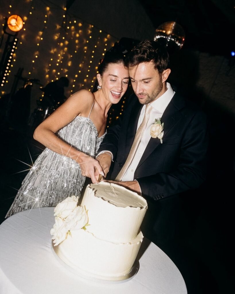 Bride and groom laughing as they cut their elegant white wedding cake at Château Rigaud, photo by Cleya Asulon.