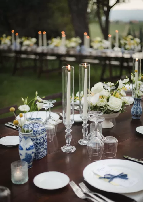 Tall candles and blue ceramics on elegant wedding table at Borgo Tre Rose