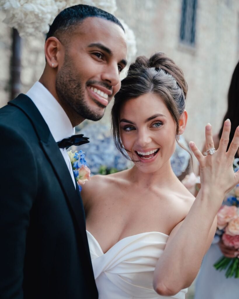 Newlywed bride showing off her engagement ring beside the groom, moments after their ceremony at Castello Montignano.