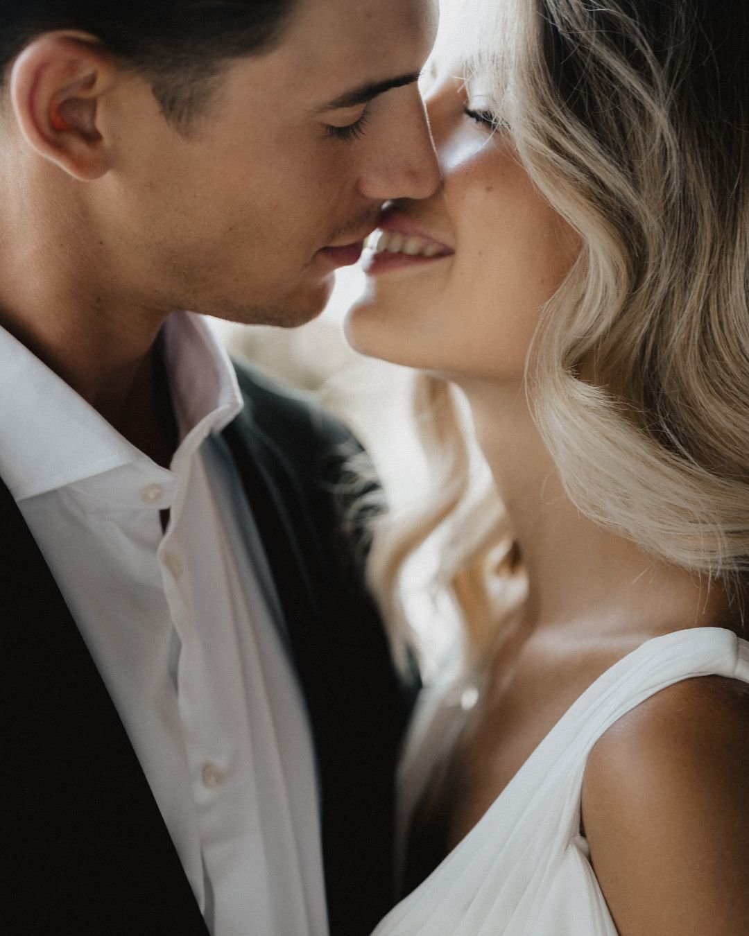 Intimate close-up portrait capturing a tender moment between bride and groom, photographed by Lukas Hanifle.