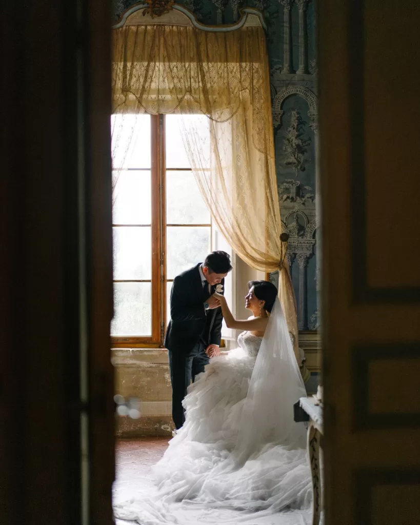 A romantic portrait of the couple inside Villa di Geggiano, framed by historic architecture and classic charm.
