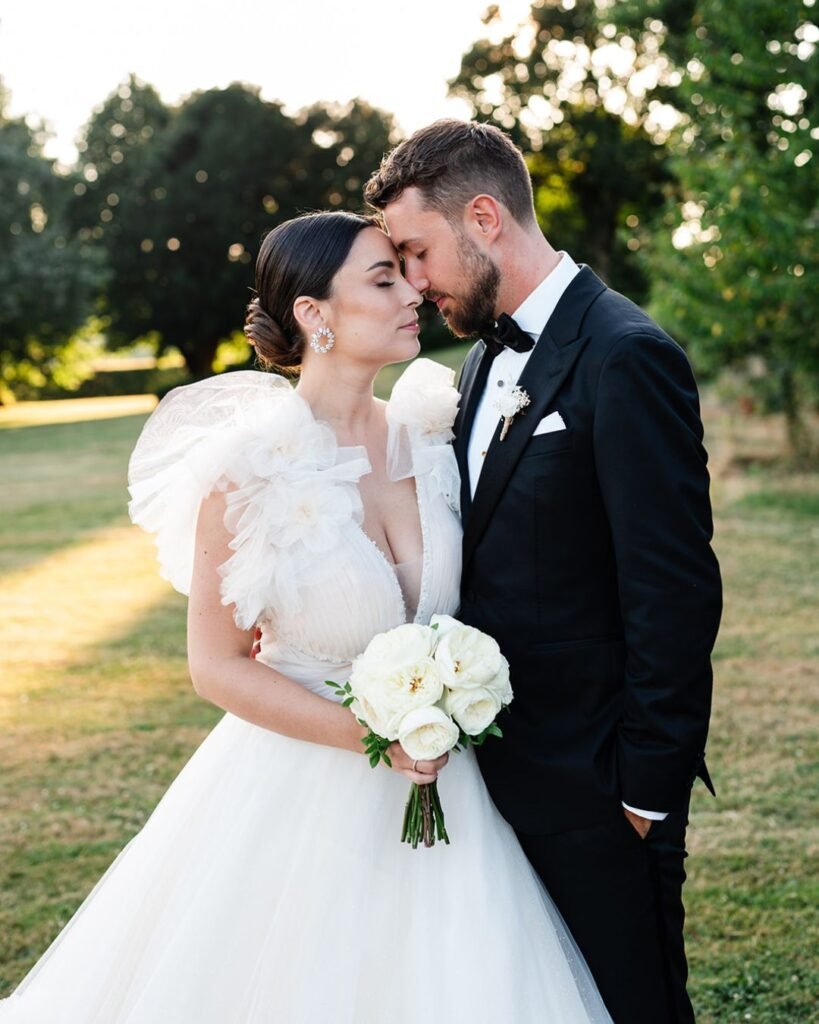 Bride and groom share an intimate moment during romantic golden hour portraits at Domaine d'Essendiéras.