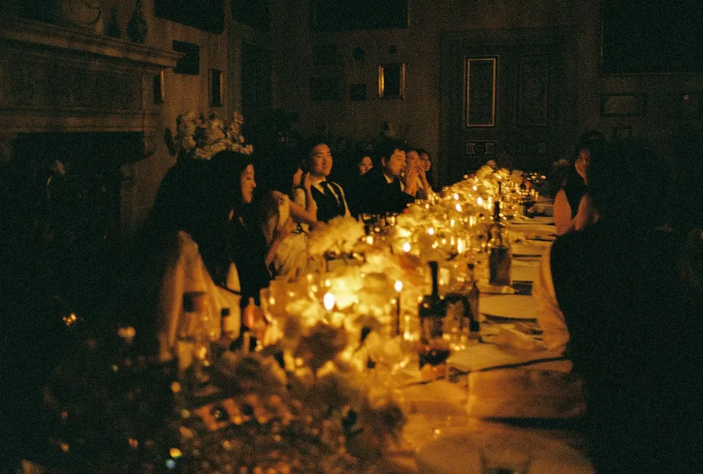 The couple shares their first dance, illuminated by candlelight in an intimate reception setting.