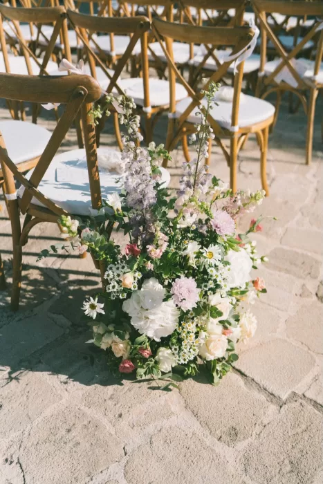 Lush pastel ceremony aisle flowers at Liopetro wedding venue.