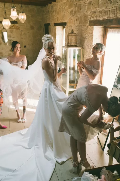 The bride getting ready with bridesmaids in a rustic stone room at Liopetro.