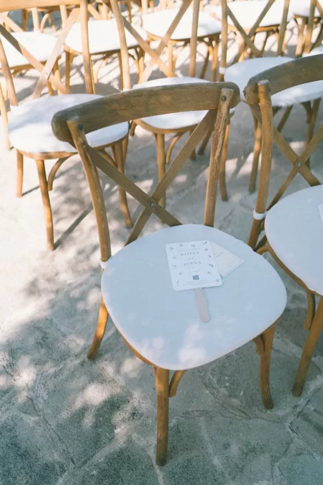 Ceremony chairs with personalised fans for guests set up outdoors at Liopetro.