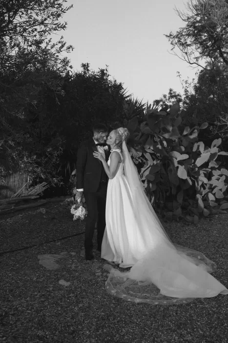 Bride and groom share a quiet moment in golden hour light at Liopetro, surrounded by lush greenery.
