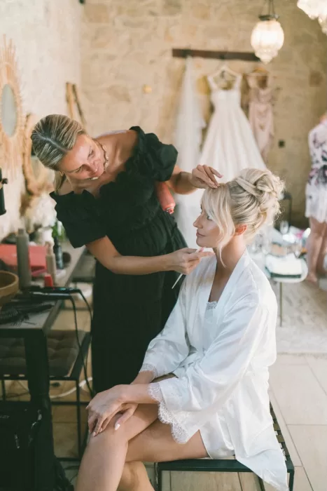 Bride having her hair styled in an elegant updo in the Liopetro bridal suite