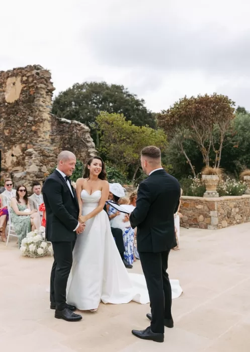 Couple exchanging vows during outdoor ceremony at Mas Torroella