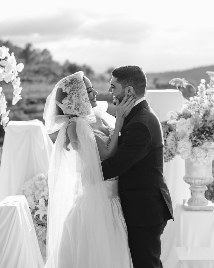 Romantic black-and-white portrait of bride and groom sharing a tender moment during ceremony at Masia Cabellut.