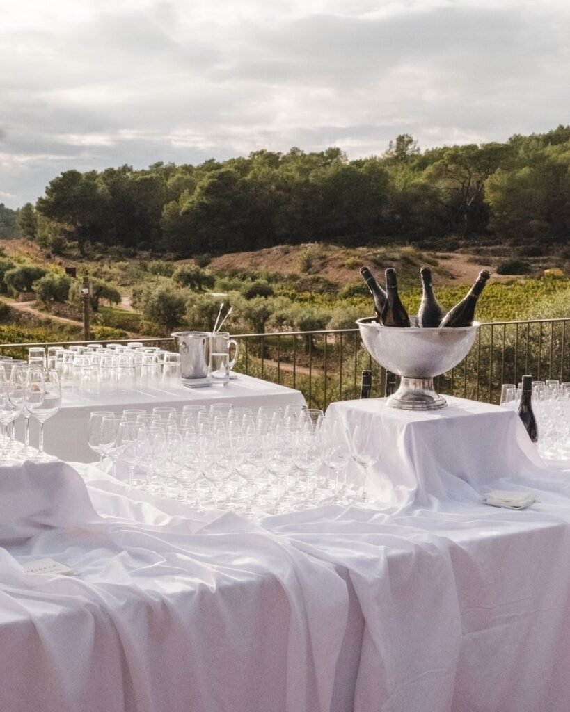 Elegant outdoor bar setup with champagne flutes and vineyard views at Masia Cabellut, perfect for al fresco celebrations.