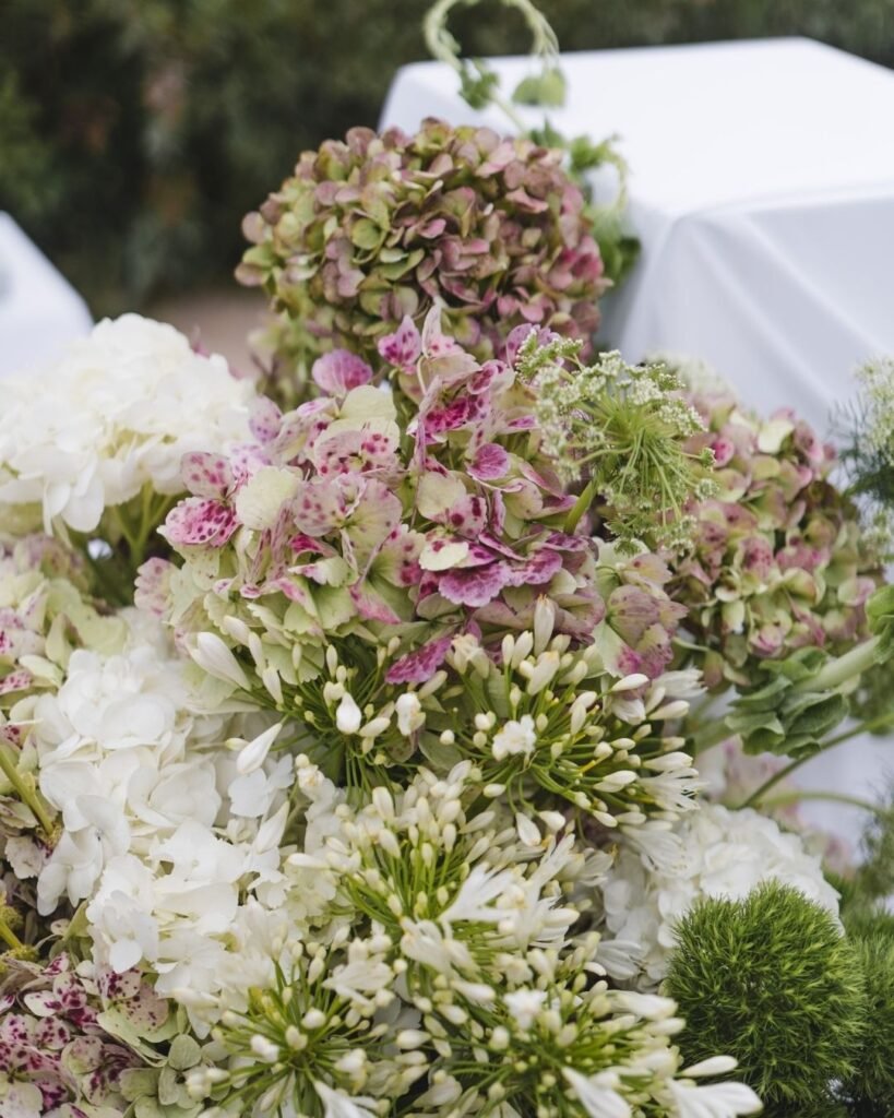 Close-up of delicate white and pastel floral arrangements from a wedding ceremony at Masia Cabellut.