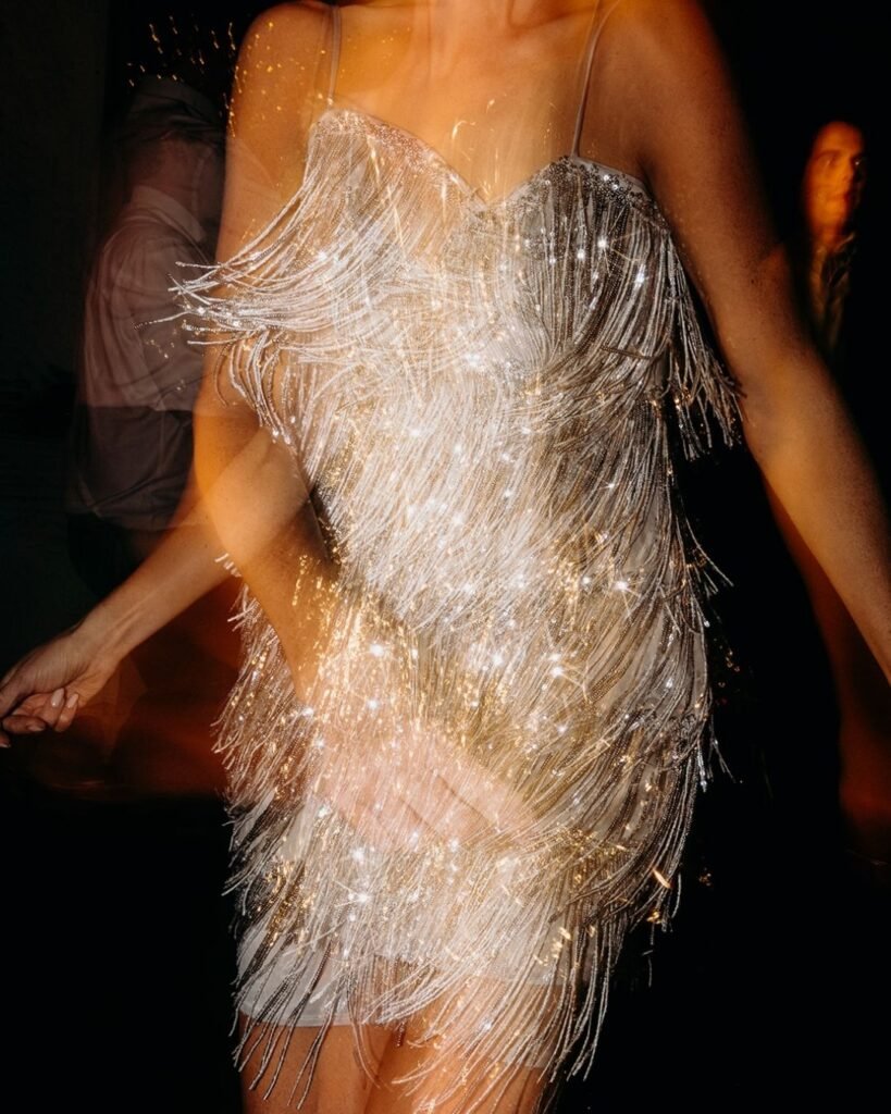 Close-up of bride’s silver sequin fringe dress sparkling in motion at Château Rigaud, by Cleya Asulon.
