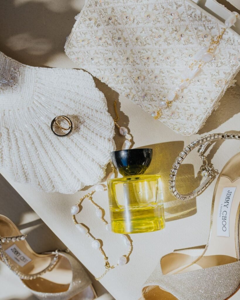 Bridal details at Six Senses Ibiza, including Jimmy Choo heels, perfume, jewellery, and pearl accessories.